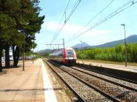 View south along the lengthy platforms at Argeles Sur Mer station as the long distance service from Cerbere to Avignon, consisting of a 4 coach 27500 class EMU, with driving vehicle 27866 leading, runs into the station on 5 August 2015.<br><br>[David Pesterfield 05/08/2015]