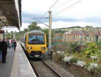Northern EMU 323225 slows for the stop at the Glossop branch terminus on 1st September 2015. It is on a service from Hadfield that will reverse here and continue to Manchester Piccadilly. <br><br>[Mark Bartlett 01/09/2015]