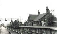 A Dalmuir - Coatbridge Central service arriving at Langloan station on 1 August 1961. At the head of the train is Dawsholm based Fairburn 2-6-4T no 42694.  <br><br>[G H Robin collection by courtesy of the Mitchell Library, Glasgow 01/08/1961]