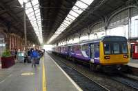 Northern Rail service to Colne awaits its departure, while passengers who had to leave an earlier service to Glasgow, await another train so they continue their journey.<br><br>[John Steven 29/09/2015]