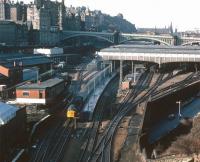 A 1977 view over the east end of Waverley from Regent Road, with a class 40 taking a train towards the Calton Tunnel. The train is passing the old East signal box, with New Street bus depot standing on the opposite side of the road bridge. Over on the left Waverley goods is still active, while beyond is the newly commissioned Edinburgh Signalling Centre. <br><br>[John Furnevel 11/10/1977]