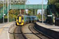 An Arriva Trains Wales service from North Wales to Manchester Piccadilly departs from Earlestown and joins the L&M line on 09 October 2015.<br><br>[John McIntyre 09/10/2015]