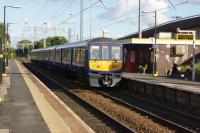 Northern Electrics unit 319386 calls at Broad Green on 09 October with a service to Liverpool Lime Street. The station is on the route of the Liverpool and Manchester Railway. On the right is the western end of the M62 motorway. <br><br>[John McIntyre 09/10/2015]
