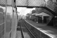 Photograph taken from a carriage window on a train leaving Clarkston station on 20 June 1964 behind BR standard tank 80120. The train is the 8.16am to Glasgow St Enoch, which will shortly pass a DMU, just visible in the background, approaching with a service for East Kilbride.    <br><br>[John Robin 20/06/1964]