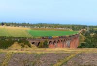 The return working of the empty ballast hoppers from Forsinard to Carlisle, pictured crossing Culloden Viaduct, double headed by 66106 and 37259.<br><br>[John Gray 15/10/2015]