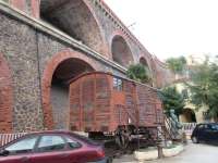 This Spanish fruit wagon is displayed on a car park in Cerbere, dwarfed by the arches that carry the main line railway and SNCF station above. Its an Iberian (broad) gauge wagon and the short length of track it stands on is mixed gauge. <br><br>[John Yellowlees 16/10/2015]