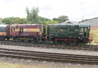 A little bit of <I>Before and After</I> on display at the Great Central Railway. Nicely restored to BR Green livery, Class 08 D3690 stands next to classmate 08694, which is in a more <I>as received</I> condition of faded EWS maroon and gold. Seen from a train departing from Loughborough Central for Leicester North. <br><br>[Mark Bartlett 29/08/2015]