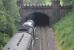 46233 <I>Duchess of Sutherland</I> enters the short artificial tunnel at Gisburn with a Cumbrian Mountain Express excursion from Liverpool on 18th July 2015. Above the castellation the northern portal can also be seen and the park land that lies in between. <br><br>[Mark Bartlett 18/07/2015]