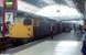 In August 1988, driver Norrie Evans of Perth walks past 26011 resting at platform 7. Beyond is a DBSO so the destination of Kings Cross is unlikely. Possibly an overnight failure at Perth taken on ECS to Dundee and then to Queen Street.<br><br>[Ewan Crawford 05/08/1988]