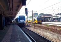 An eastbound Sprinter Lighttrein, bound for Utrecht (left), arrives at Gouda on 16 July 2015. These have largely replaced the Mat 64 emus from the 1960s and 1970s, although the old stagers had to be recalled in the winters of 2010 and 2012 following many SLTs failing in snow and freezing conditions.  On the right a westbound DD-VIRM set pauses for custom.<br><br>[Andrew Wilson 16/07/2015]
