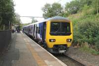 Class 323 25kv EMU 323228 at Hadfield on 1st September 2015 about to depart for Manchester. [See image 21021] from 1983 at this location. <br><br>[Mark Bartlett 01/09/2015]