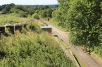 Looking over Donyatt Halt, on the Ilminster to Chard section of the Taunton to Chard line, which closed in 1962. The concrete structures on the lineside and trackbed are part of the <I>Taunton Stop Line</I>, built to impede any German forces advancing on Bristol from the west during WWII. [Ref query 36652]<br><br>[Mark Bartlett 25/07/2015]