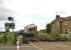 A westbound train passing the site of Low Row station, between Haltwhistle and Brampton, on 17 July 2015. The DMU has just passed the new signal box built in 2009 to replace the original which stood behind the camera alongside the level crossing [see image 36655]. [Ref query 368]<br><br>[Ken Strachan 17/07/2015]