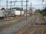 A RegioRail shunting loco hauls a rake of covered  steel carriers out of the general transhipment yard, to the north of the east yard road to rail facility at Le Boulou, that is sited alongside the northbound access slip-road to the A9 E15 autoroute. SNCF Fret electric loco 427029 is seen at left of view [See image 52588].   <br><br>[David Pesterfield 05/08/2015]