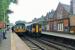 The fine looking station building at Romiley is still fully staffed and the station enjoys regular services to Manchester Piccadilly via both Hyde and Reddish. Here a Pacer heading for the Rose Hill branch meets a Sprinter going into the city on 1st September 2015.<br><br>[Mark Bartlett 01/09/2015]