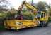 A road/rail vehicle parked at the side of the road near the viaduct awaiting use on the overnight renovation works. The east end of the viaduct are can just be seen above the cab. <br><br>[Colin McDonald 20/10/2015]