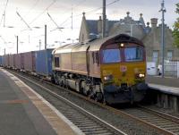 DBS 66176 coasts through Kirknewton with a well-loaded intermodal service from Mossend to Tees Dock, a fairly new introduction.<br><br>[Bill Roberton 23/10/2015]