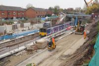 A Manchester Victoria to Clitheroe service passes Farnworth station. The station remains closed as work continues with the new platforms which have been realigned with the rebored tunnel to the right.<br><br>[John McIntyre 31/10/2015]