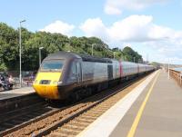 A Cross Country HST hurries through Dawlish with a Plymouth to Edinburgh service on 29th July 2015. Power car 43321 brings up the rear as the train passes the platforms where there is much evidence of refurbishment work after the winter storm damage.<br><br>[Mark Bartlett 29/07/2015]