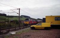 47773 with a headboard 'The Capital Express' heads south at Beattock with a rake of maroon Mk1 coaches on 06 August 1994. The yellow BR vans add a bit of colour to the shot on what was a rather dull day.<br><br>[John McIntyre 06/08/1994]