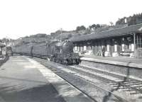 Parkhead V1 67674 entering Hillfoot station, shortly after setting out from Milngavie with a train for Airdrie in July 1957. <br><br>[G H Robin collection by courtesy of the Mitchell Library, Glasgow 02/07/1957]