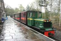 A wet day at Alston on 6 May 2006. At the platform is South Tynedale Railway No 4  <I>Naworth</I> [Hudswell Clarke 0-6-0DM No 4 of 1952]. This example was originally supplied to the NCB as an underground flameproof mine locomotive, suitably modified and distributed by the Huwood Mining Machinery Co of Team Valley, Gateshead. No 4 was previously employed at Horden Colliery in County Durham. The manufacturers nameplate displayed on the front of the locomotive is Huwood-Hudswell. <br><br>[John Furnevel 06/05/2006]