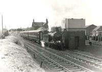 The BLS Bathgate and District Railtour of 6 May 1961 ran from Maryhill Central and covered various branches between Glasgow and the West Lothian town before finally returning to Queen Street. The special, which was hauled throughout by Eastfield shed's N15 0-6-2T no 69163, is seen here taking water at Baillieston on the outward journey. [See image 48701]<br><br>[G H Robin collection by courtesy of the Mitchell Library, Glasgow 06/05/1961]