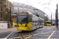 Metrolink trams approach and depart from Manchester Victoria on 10 December. These trams are on the original route via Piccadilly Gardens. To the left is the second city crossing via Exchange Square.<br><br>[John McIntyre 10/12/2015]