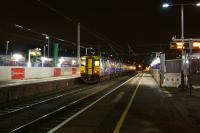 A pair of Northern Class 150s at Leyland after dark on 7 December 2015. The two green columns on the left (platform 4) are supports for the new footbridge and steps, scheduled for installation over the Christmas shutdown period.<br><br>[John McIntyre 07/12/2015]