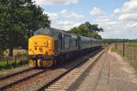 On summer Saturdays in 2015, Norwich-Yarmouth services included this heavyweight formation of two Class 37s (37405 plus 37425) and three carriages shuttling backwards and forwards via Reedham. The ratio of genuine passengers to enthusiasts on these trains is an interesting topic for speculation. This photo shows the ensemble roaring back to Norwich through Buckenham station on July 18th.<br><br>[Mark Dufton 18/07/2015]