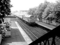 A class 47 hauled train passing east through Slateford station on its way to Waverley in May 1981, prior to demolition of the old station buildings. The train is the Edinburgh portion of a down WCML service which had been split at Carstairs. <br><br>[John Furnevel 07/05/1981]