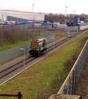It's a lonely life a-shunting. Malcolm group locomotive 08823 returns to the main yard at DIRFT on 18 December 2015 after depositing a rake of Cargowaggons by the Eddie Stobart warehouse [see image 53111]. The Northampton loop off the WCML is out of view to the right of the concrete fence.<br><br>[Ken Strachan 18/12/2015]