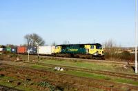 Freightliner 70011 takes an eastbound Freightliner past Didcot station on 23rd December 2015. <br><br>[Peter Todd 23/12/2015]