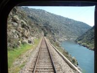 The view from the rear corridor connection door of a Pocinho to Porto service as it heads down the Douro Valley near Alegria in March 2008. This view taken in the valley below the river dam. [See image 18539] for the lineside view above that structure.<br><br>[Mark Bartlett 20/03/2008]