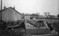This is the remains of the former Ardmore Level Crossing SB after it was destroyed by fire in the early 1970s. At the time the box had been in use as a PWay bothy and store, having been replaced by a new box diagonally across the LC (out of shot to the left) in 1943 when the Ardmore marshalling yard was opened. That box closed in 1976. Today there is only an REB to house the equipment for the AHB level crossing.<br><br>[John McIntyre //]