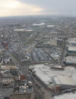 Blackpool Central station site as seen from the Tower in January 2016. It is over fifty years since it closed in 1964 but, from above, the former railway land can still be identified. The white building in the foreground is Coral Island, which occupies the site of the old terminus building. The car parks are laid over the fourteen platforms and the M55 link road goes south along the old formation through Bloomfield Road towards the still open Blackpool South. The tall red brick building at the far left of the car park is the old railwaymen's lodging house, now holiday flats. <br><br>[Mark Bartlett 16/01/2016]