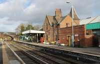 Once a busy station on the four track main line to Birkenhead Woodside, Hooton later went into decline. However electrification in 1985, subsequently extended to Chester and Ellesmere Port has brought a revival and there are now six trains an hour direct to Liverpool for most of the day. The <I>siding</I> in the foreground however, used for a period by the Helsby DMU shuttle, is now redundant as the EMUs call at the other platforms but the station building is still staffed and in good repair. <br><br>[Mark Bartlett 16/11/2015]