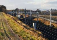 On 24th November 2015, two Class 170 DMUs on Edinburgh/Glasgow duties pass on a section of track east of Linlithgow which has the OHLE wiring installed. <br><br>[Colin McDonald 24/11/2015]