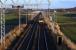 Progress on the electrification just over a mile east of Linlithgow on 24th November 2015 as a mid-afternoon Edinburgh - Glasgow Queen Street service approaches. [See image 51344] <br><br>[Colin McDonald 24/11/2015]