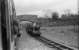 A view from an eastbound train arriving at Irton Road on the Ravenglass and Eskdale Railway as a service for Ravenglass waits in the loop on 30 May 1972.<br><br>[John McIntyre 30/05/1972]