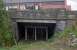 In 1988 the cutting between Maryhill Road and the Forth and Clyde Canal was filled in. The station site, seen beyond the bridge, was filled in for the Maryhill Shopping Centre which in turn has become a Tesco. Behind the camera the line continued east to Possil with a siding to the Maryhill Iron Works branching off to the north. This view is no longer possible with the ground level now raised to the height of the roadway.<br><br>[Ewan Crawford //1988]