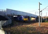 The 1049 Newton - Glasgow Central passes under the now reopened Old Mill Road bridge across the WCML at Cambuslang on 10th December 2015. [see image 51404].<br><br>[Colin McDonald 10/12/2015]