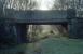 The site of Killearn station in 1990. The station (which was largely timber) closed to passengers in 1951 and little survives apart from a stationmaster's house and this overbridge (since replaced). [See image 6772] [Ref query 36140]. The few remains at the site were largely removed during the construction of the Loch Lomond Water Supply Scheme.<br><br>[Ewan Crawford //1990]