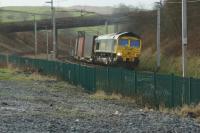A Daventry to Coatbridge Freightliner container train rounds the curve between Grayrigg loops and Low Gill in the early afternoon of 23 January 2016.<br><br>[John McIntyre 23/01/2016]