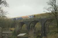 One mile north of the famous Ais Gill Summit, this less well known viaduct crosses the actual Ais Gill beck. 158784, on a Northern service from Carlisle to Skipton, passes over the bridge on the last stages of the climb on 1st February 2016.<br><br>[Mark Bartlett 01/02/2016]