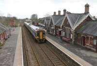 Northern 158860 leads a four car Leeds - Carlisle service into Appleby station on 29th January 2016. This view from the station footbridge shows the well preserved station buildings to good effect. For several years, GWR 4-6-0 4979 <I>Wootton Hall</I> sat alongside the line here awaiting restoration [See image 47466] but in October 2014 the Furness Railway Trust moved it to the Ribble Steam Railway where it is now kept under cover and work has started.<br><br>[Mark Bartlett 29/01/2016]