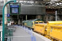 Sunday morning engineering work on the north side of Waverley in February 2006 in connection with the new 'Balmoral' through platform. Freightliner 66607 edges forward along platform 1 with a ballast train.<br><br>[John Furnevel 26/02/2006]