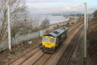 Possibly on a test run after repair, Freightliner 66598 ran light engine from Crewe to Carnforth and back on 12th February 2016. The loco is seen here on the northbound leg running past the incoming tide on a sunny afternoon at Hest Bank.<br><br>[Mark Bartlett 12/02/2016]