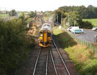 A Carlisle - Glasgow Central DMU comes off the double track section from Gretna Junction and approaches the platform at Gretna Green on 12 October 2006. Preparatory work in connection with the redoubling of the route between here and Annan is underway on the left. <br><br>[John Furnevel 12/10/2006]