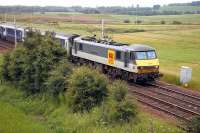 The Glasgow portion of the Lowland Sleeper passing Ravenstruther early on 11 July 2006. EWS 90022 brought the train north from Euston and has recently dropped the rear 7 coaches at Carstairs. [See image 49805].<br><br>[John Furnevel /07/2006]